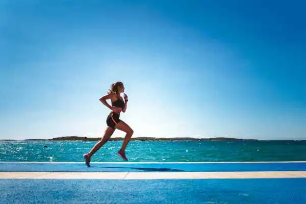 Woman running showing strong leg muscle Bracknell